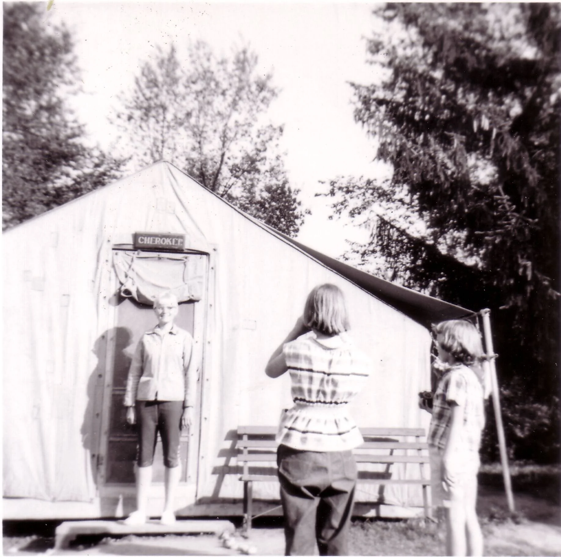 1957 - Camper taking a photo in front of the Cherokee tent