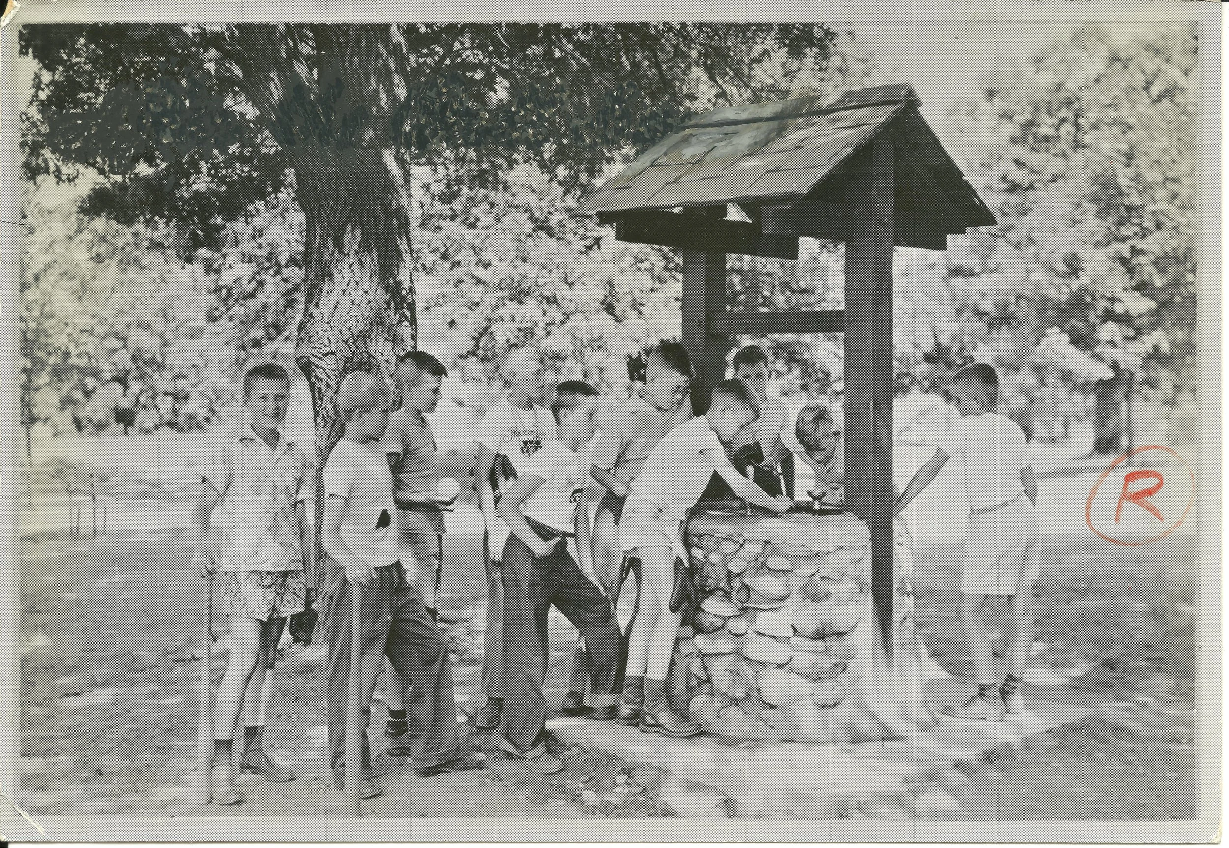 1940s - Boys drinking from the fountain in the well
