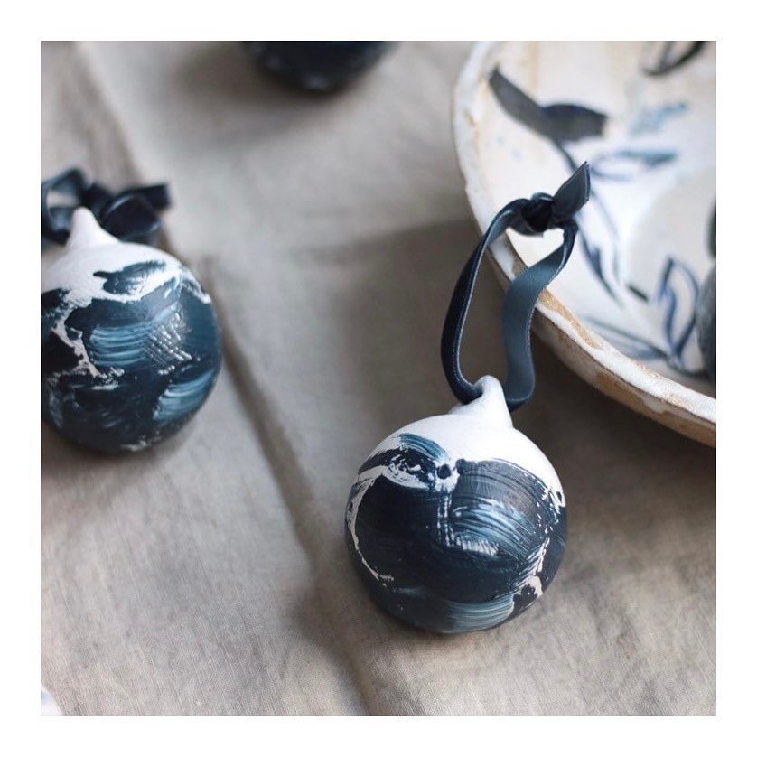 An elegant set of ceramic baubles, each designed by @olivialucybush Each one is finished with a velvet hanging ribbon and all proceeds being donated to shelter box. 

Olivia Lucy is a printmaker and freelance book designer, living and working in Sout
