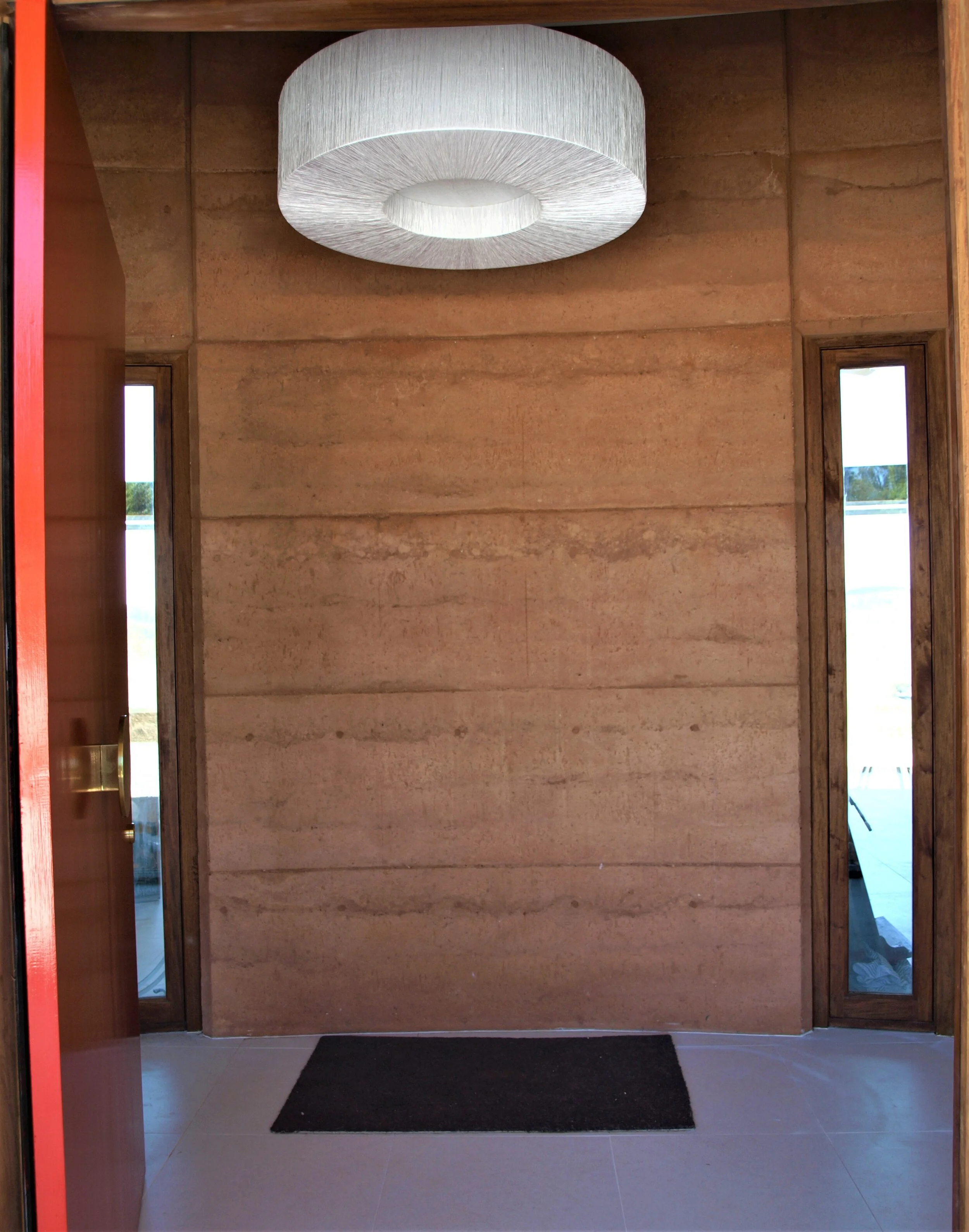 entry hall with narrow windows framing the view beyond