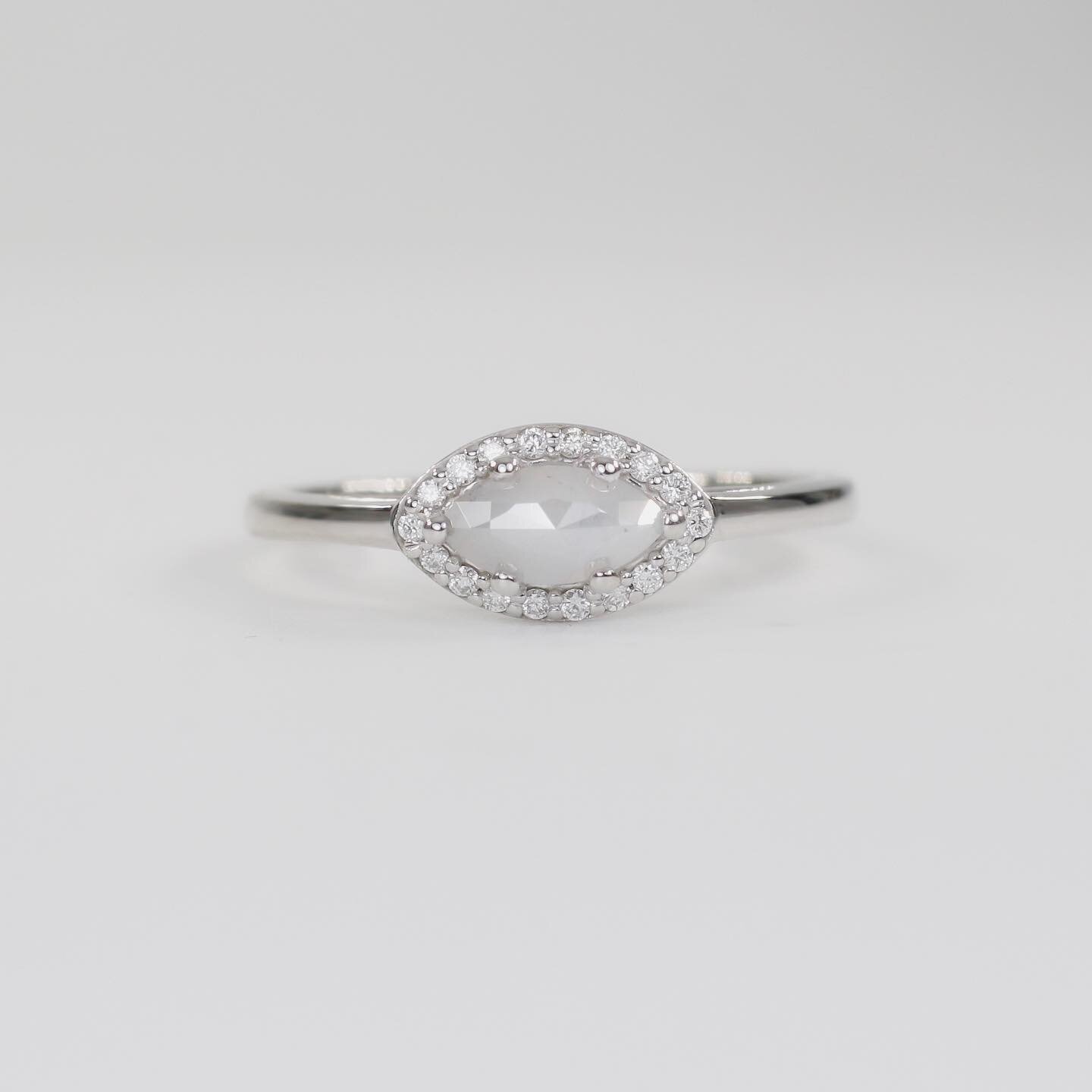 Meet &lsquo;Aeni&rsquo;, a stylish one-off ring design created around a stunning milky grey diamond set in 14ct white gold with a halo of white diamond accents. Ready to ship now with 10% off using code DECEMBER. Don&rsquo;t know the ring size? Don&r