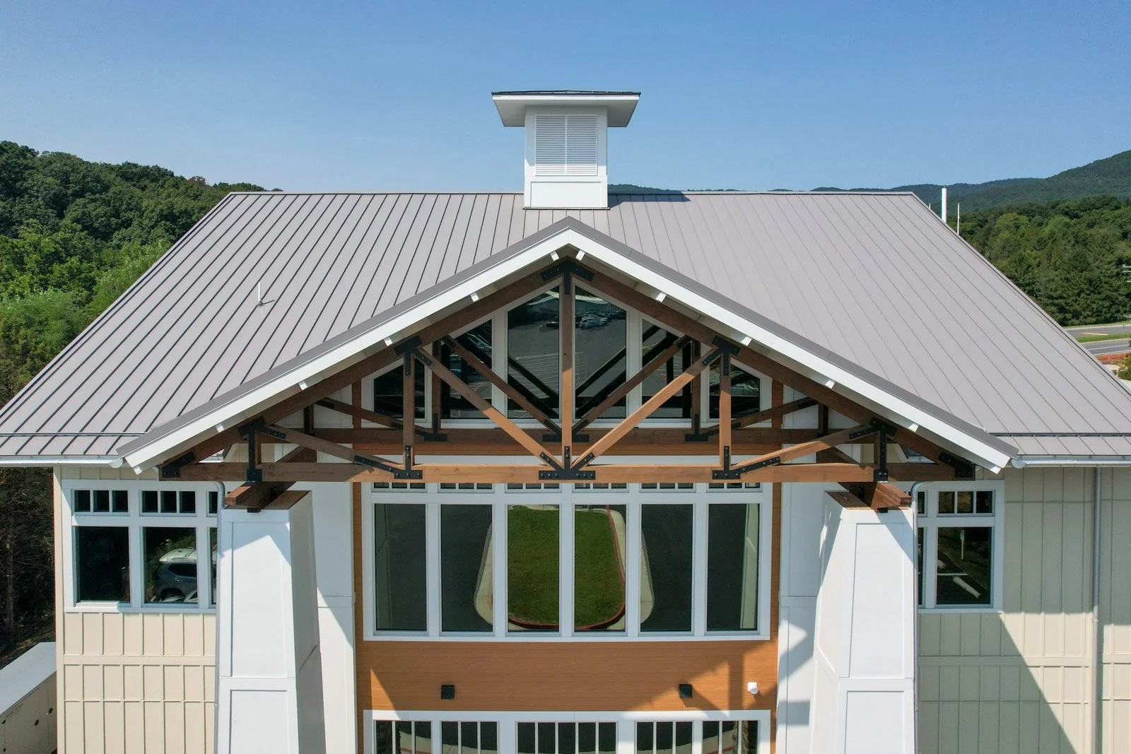 Front view of the Massanutten Timeshare Building’s standing-seam metal roof and timber-framed entrance.
