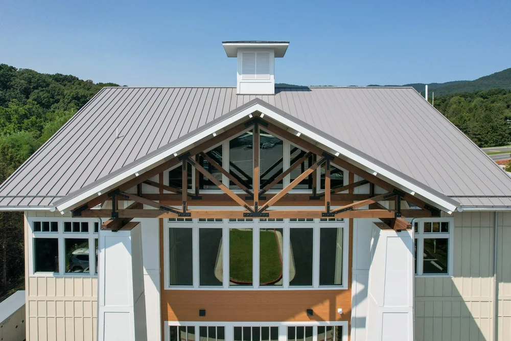 Front view of the Massanutten Timeshare Building’s standing-seam metal roof and timber-framed entrance.
