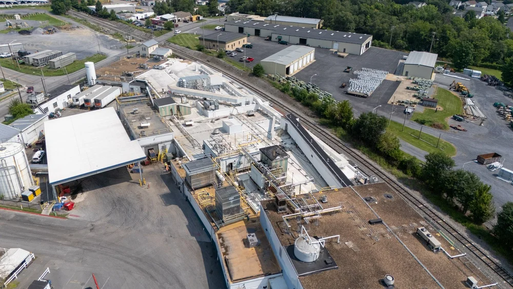 Drone view of the white TPO roofing system installed across the Farmer Focus industrial facility.