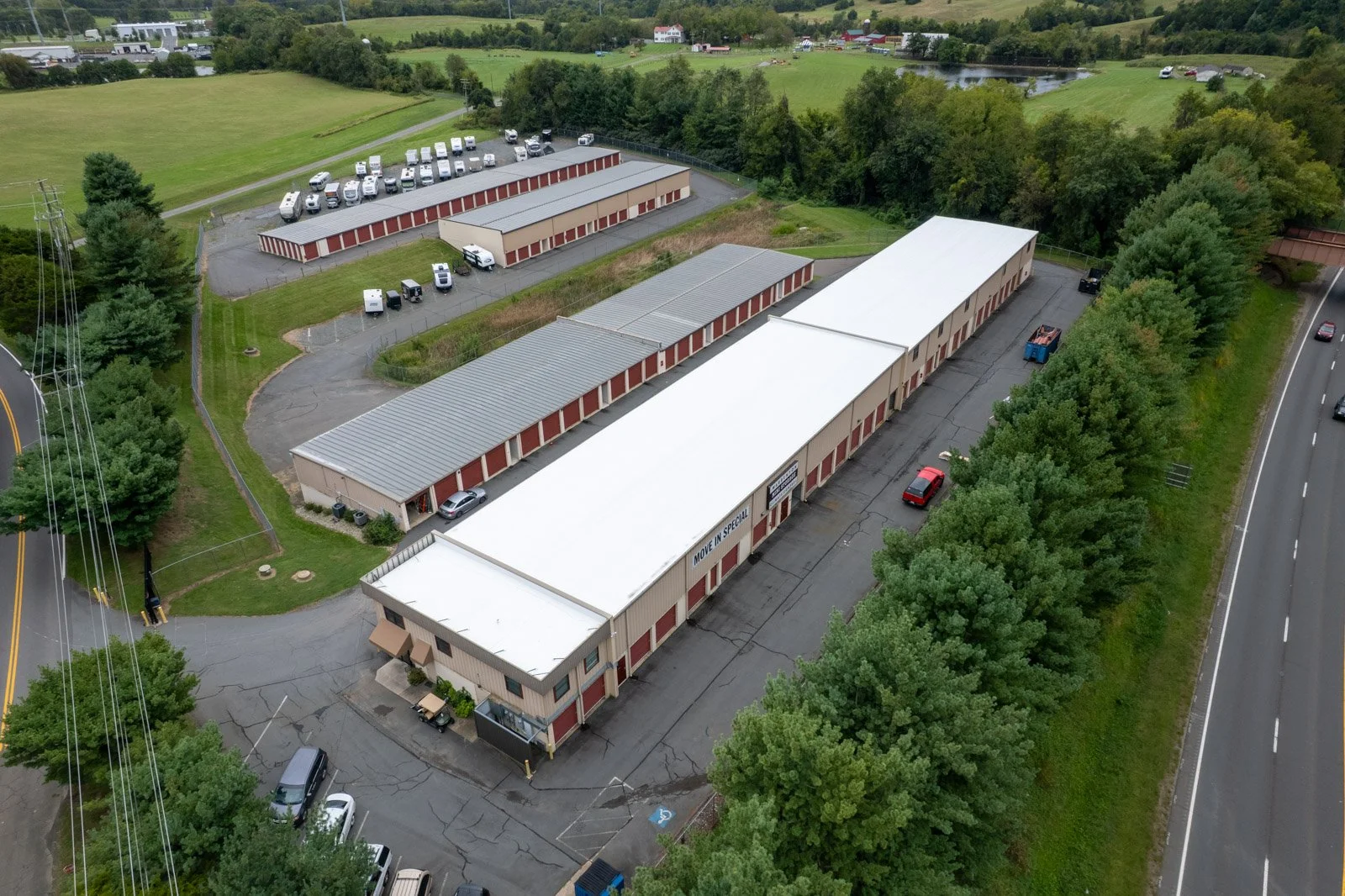 Aerial view of Warrenton Mini Storage’s white TPO roof alongside metal-roofed storage buildings and RV parking.