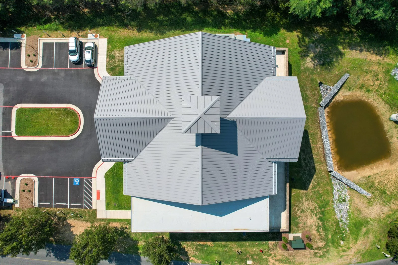Top-down view of the timeshare building’s coordinated metal and low-slope TPO roof sections.