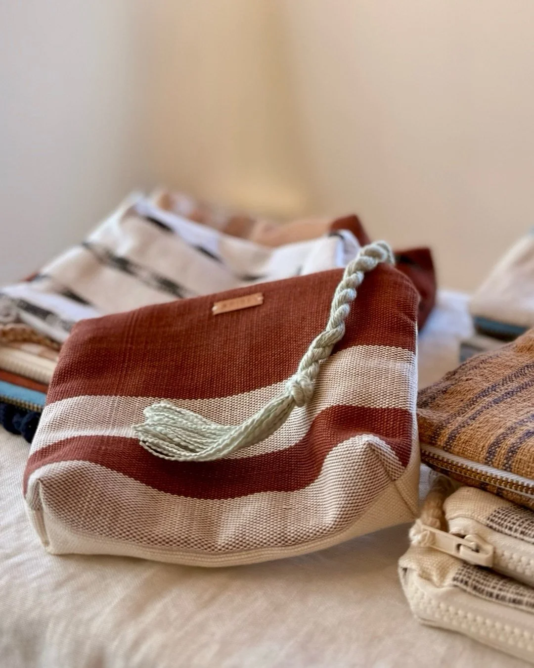 Very excited about my latest collection of handwoven, one-of-a-kind, zipper pouches, available exclusively in the exquisite gallery, @folklore.santafe.

Each has a unique story. The brown stripe fabric is all naturally dyed in Lake Atitlan as part of