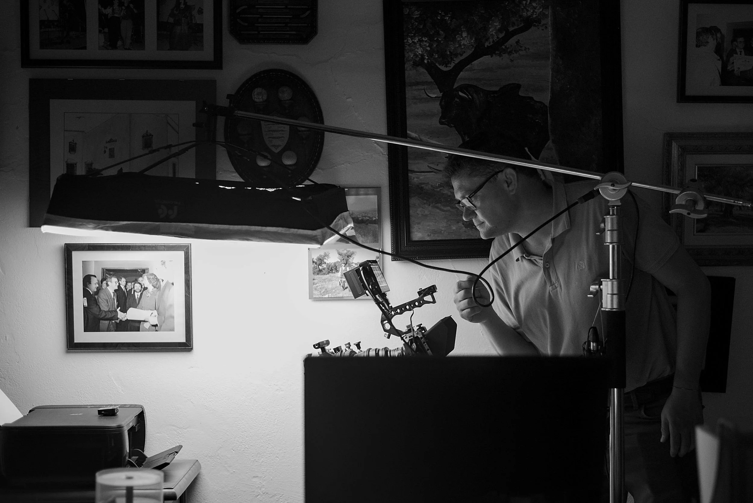 Director of photography leaning over the camera, checking framing and light.