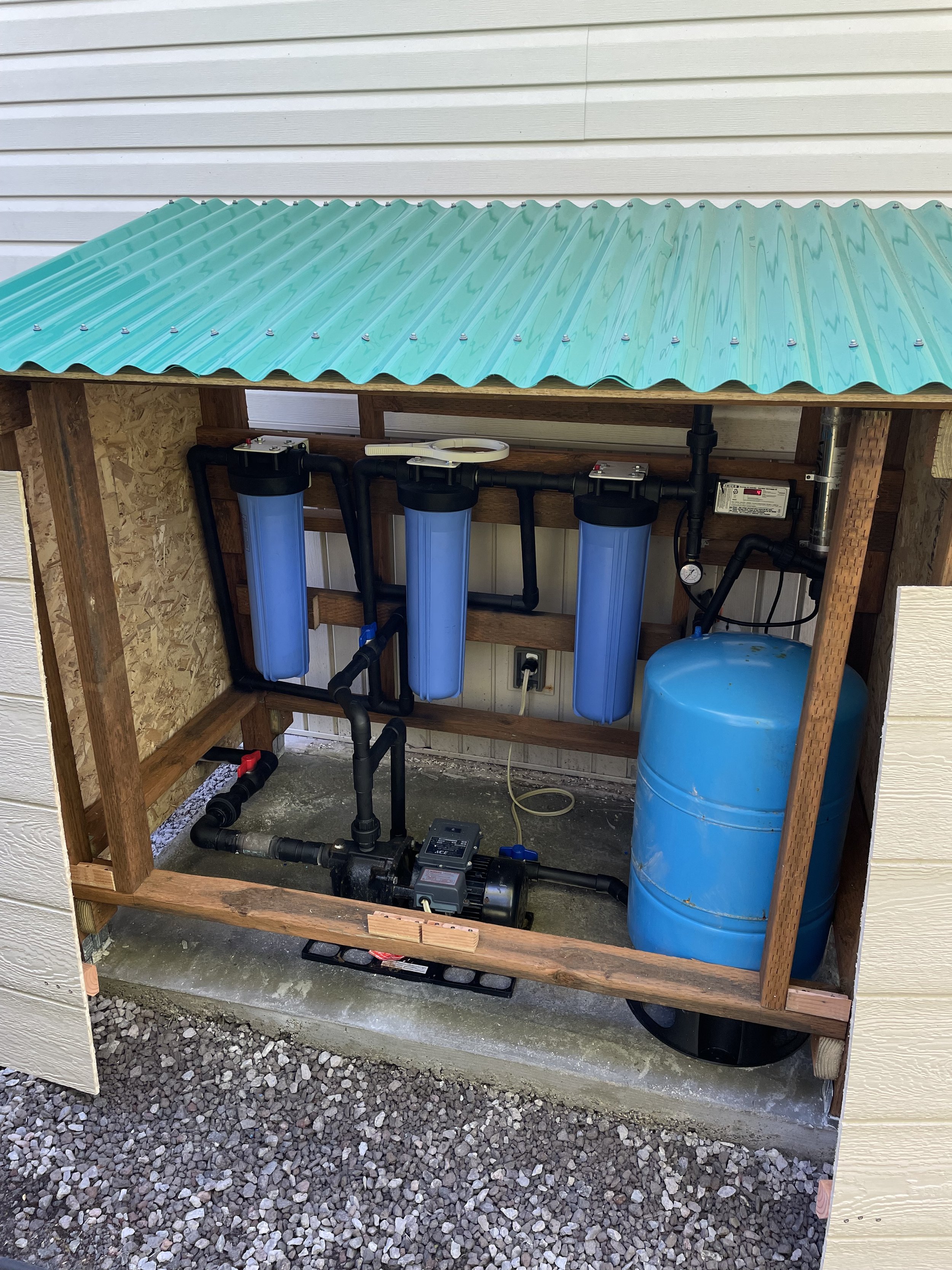 The filters have been installed, the pump and pressure tank connected, and running.