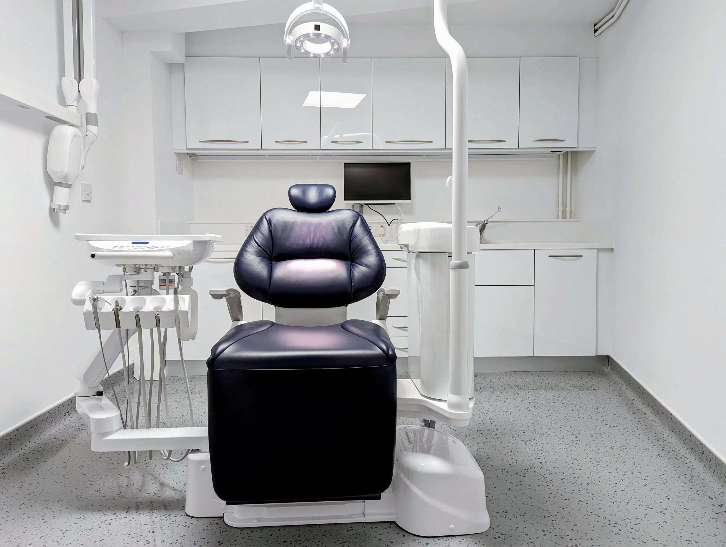 Our second refurbished surgery, with a padded dental chair, digital X-ray equipment and white cabinetry.