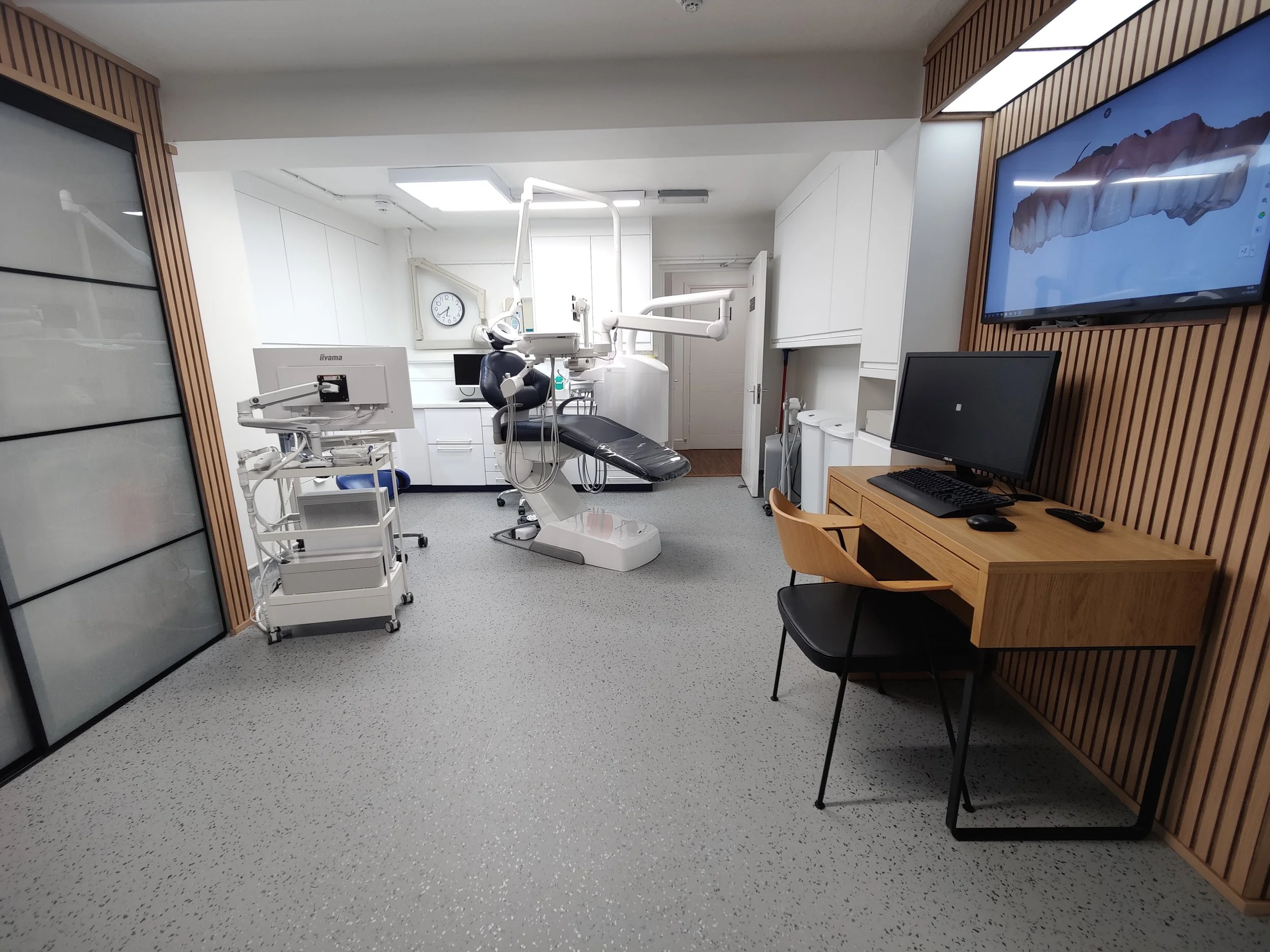 An updated surgery at The Yorkshire Grey, with a padded dental chair, wood panelling and a consultation desk.