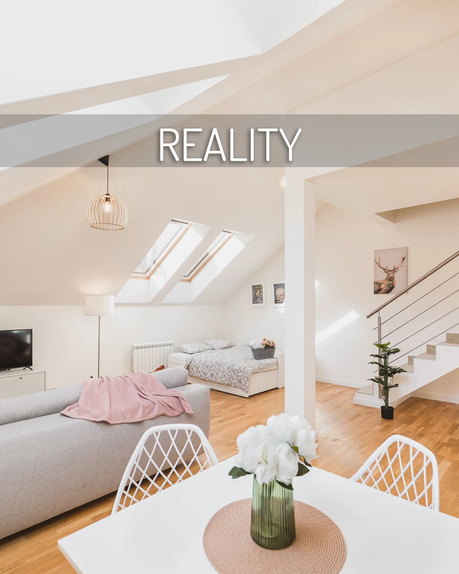 A bright living room with a white dining table and chairs, a beige sofa with a pink blanket, a flat-screen TV, twin skylights, and wall art including a deer portrait, all with light wooden flooring and a staircase with a potted plant nearby.
