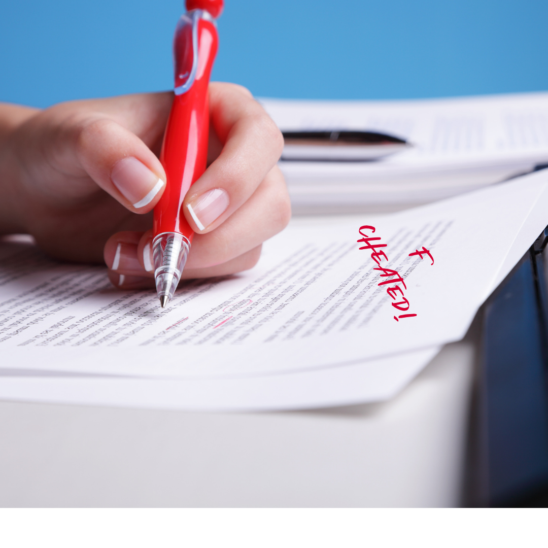hand with a red pen writing the words "F - Cheated"