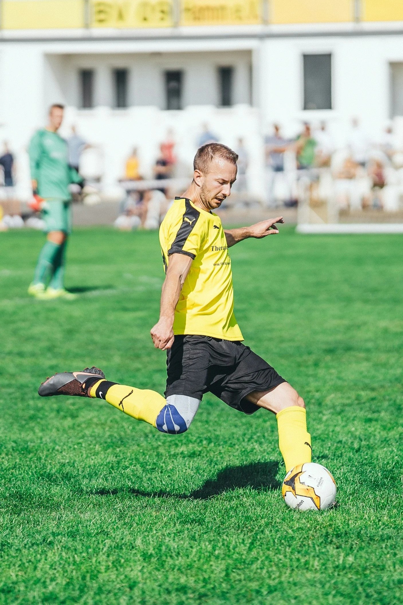 soccer player kicking ball