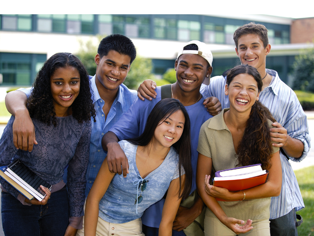 six smiling students holding books