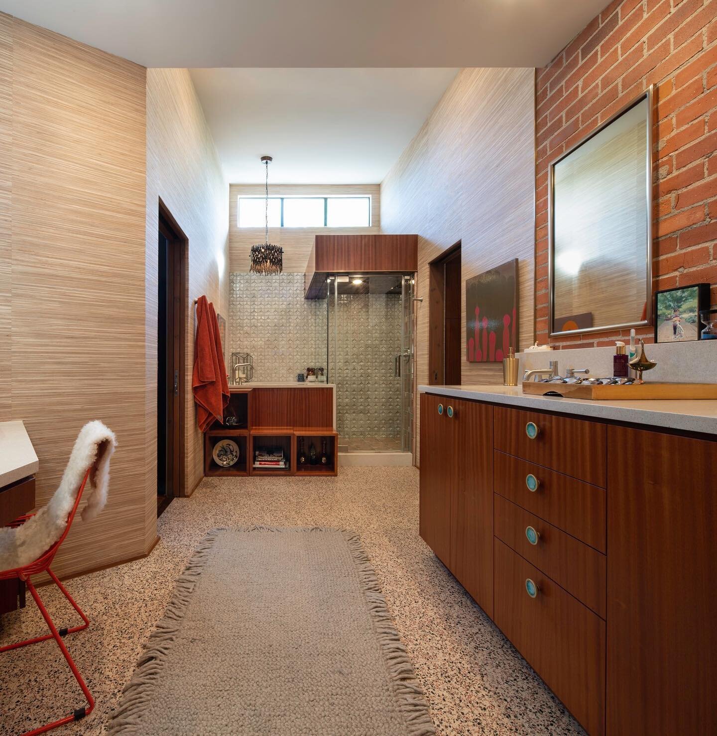 The Japanese soaking tub sits along side the steam shower and the ceiling steps up to make room for more #clerestory windows that face the southeast, which get great morning light. Since the tub is so deep, we designed moveable boxes in front of it t