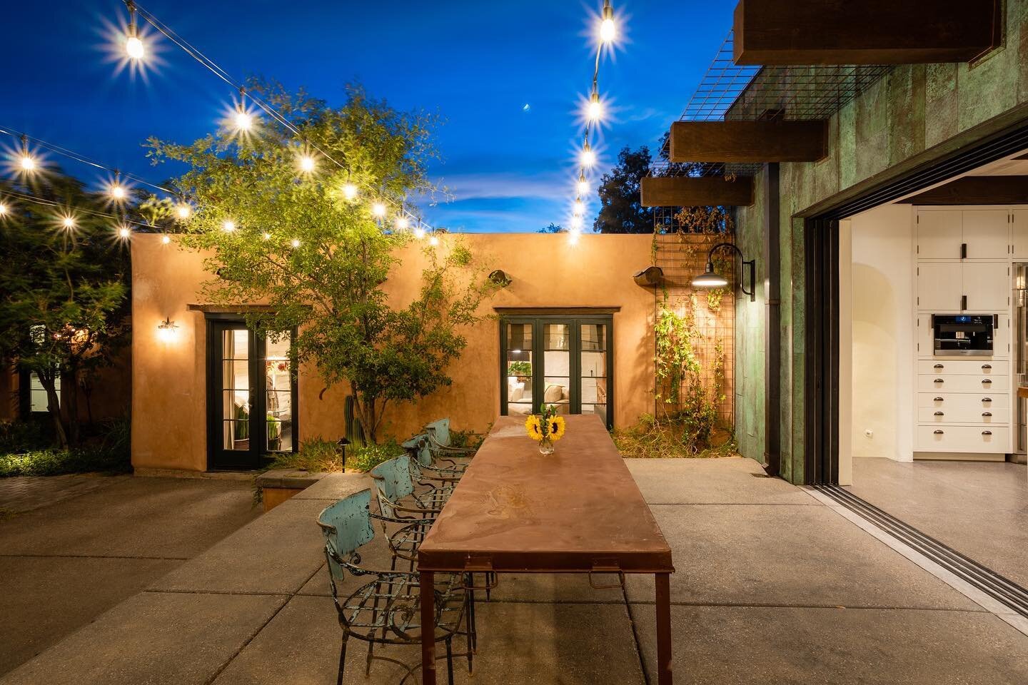 This is #indooroutdoorliving at its finest, where the kitchen and outdoor dining meet with custom steel and glass doors that pocket completely into the walls on one side and the natural turf on the other side of the courtyard. #courtyards were part o