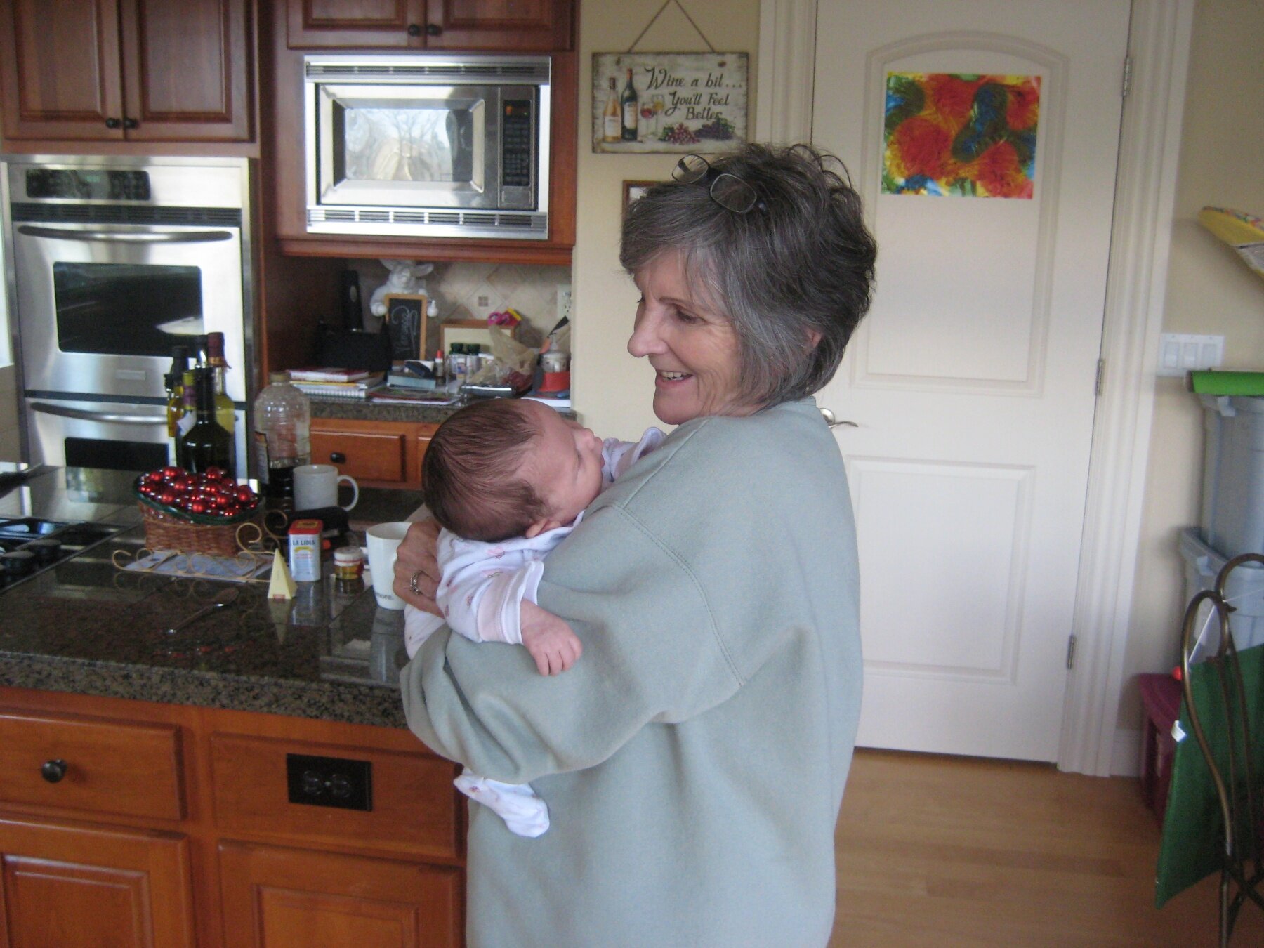 A beautiful grandmother holding a beautiful new baby granddaughter Addison
