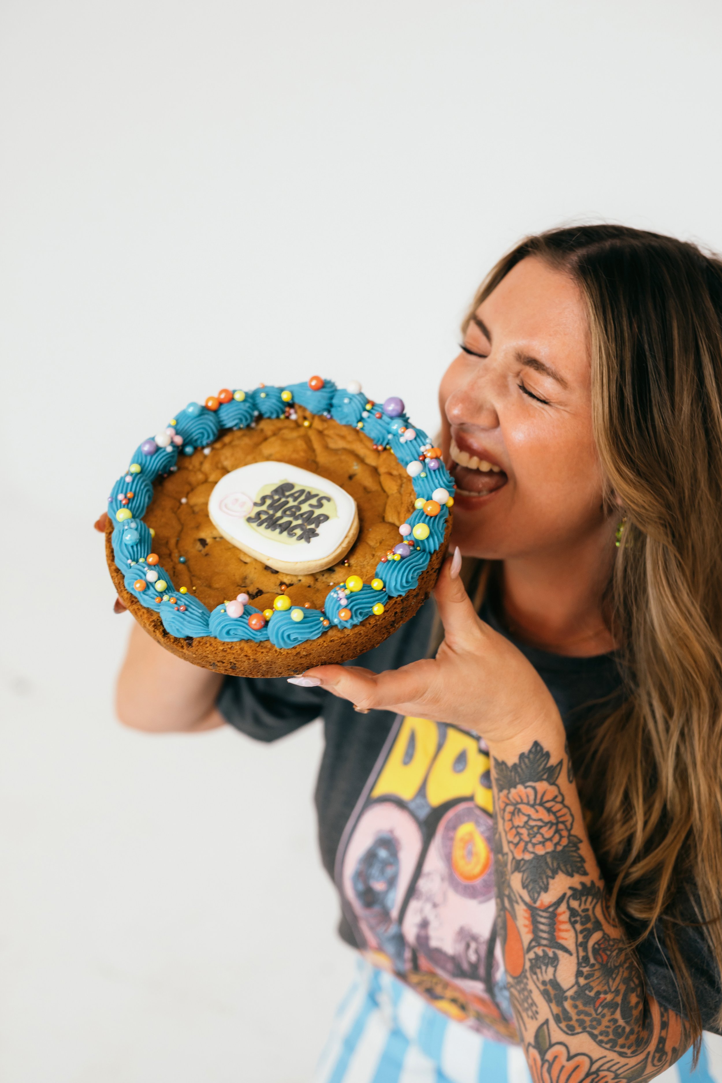 Lifestyle branding photoshoot for Orange County cookie decorator featuring playful poses, decorated cookies, and personality-driven content for social media marketing. Captured by Southern California lifestyle marketing and branding portrait photogra