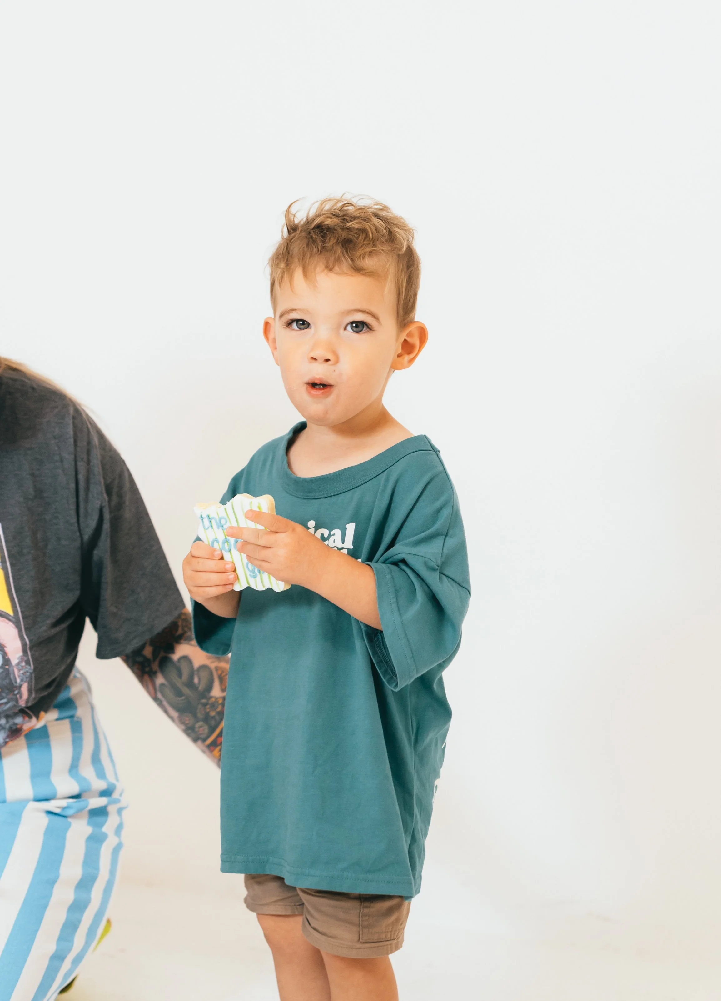Orange County home baker posing in bright pink dress during studio branding photoshoot for cookie decorating business. Modern small business branding photography with bold color lighting and confident female entrepreneur energy. Photographed by South