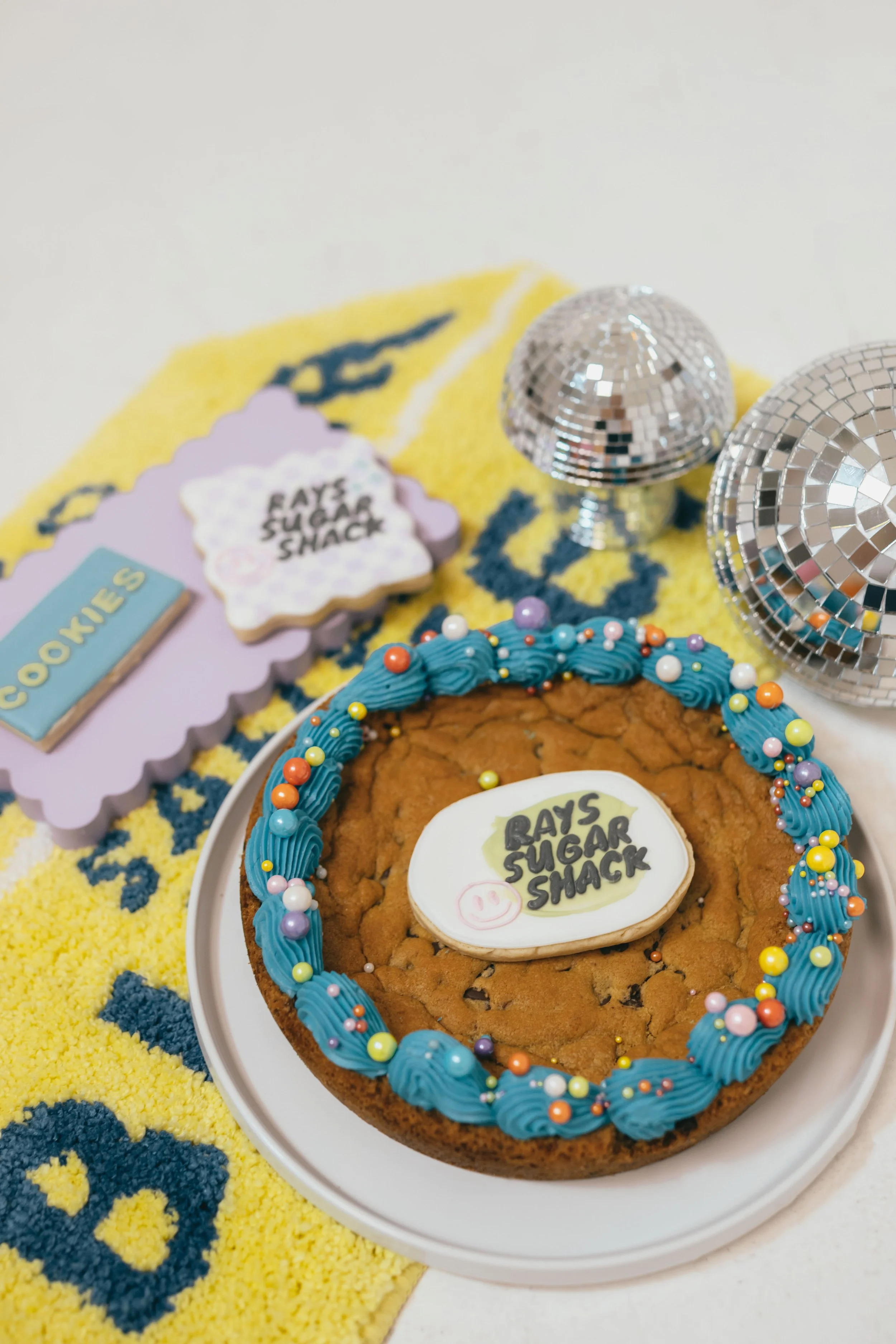 Lifestyle branding photoshoot for Orange County cookie decorator featuring playful poses, decorated cookies, and personality-driven content for social media marketing. Captured by Southern California lifestyle marketing and branding portrait photogra