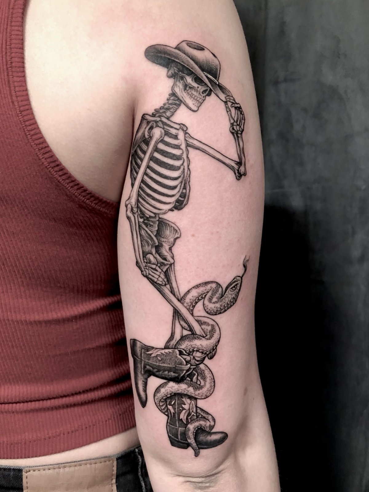 Fine line black and grey skeleton cowboy with snake tattoo, created by Seattle tattoo artist Eli Bischof.