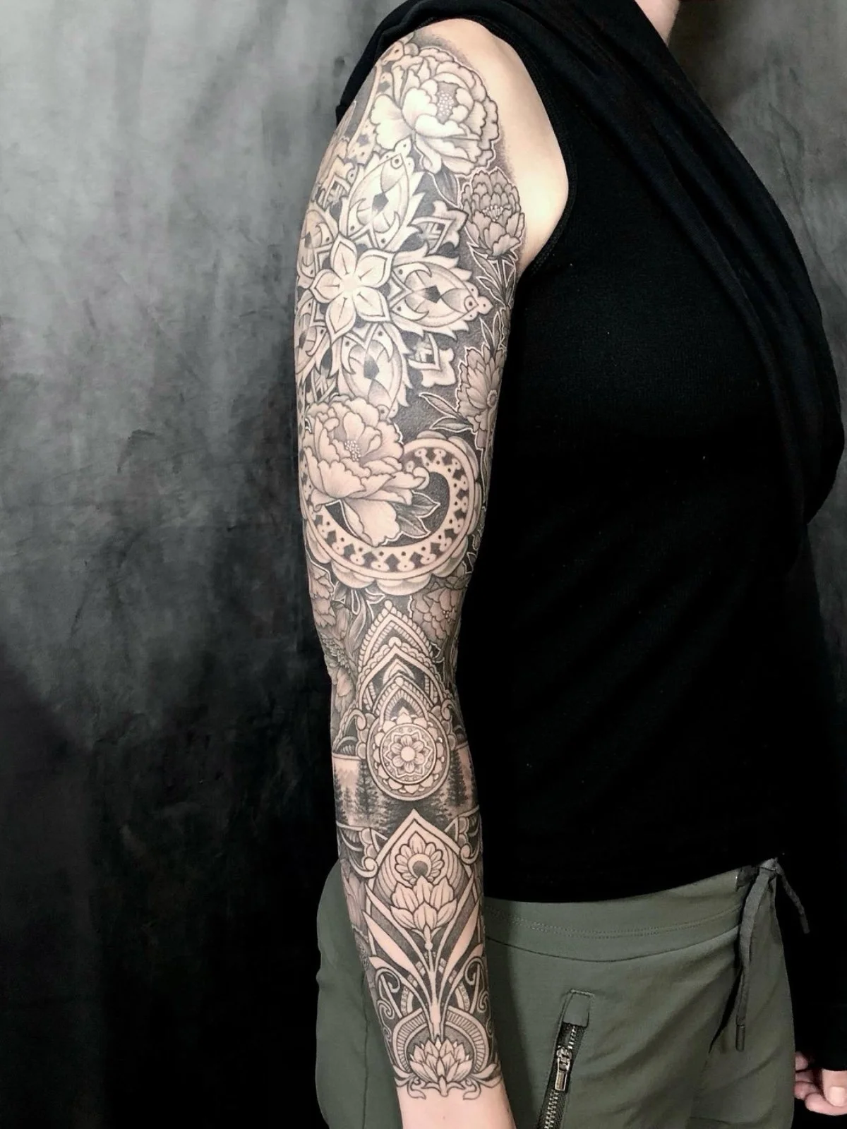 Healed fine line black and grey sleeve tattoo, with geometric elements, mandalas, and flowers, created by Seattle tattoo artist Eli Bischof