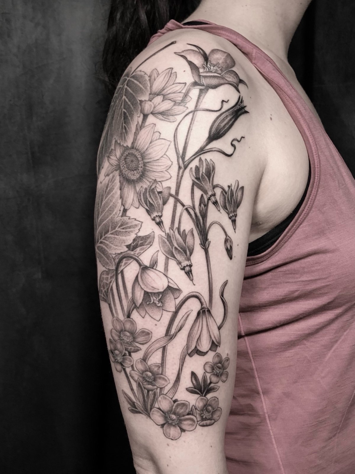 Fine line black and grey half sleeve tattoo with PNW wildflowers, created by Seattle tattoo artist Eli Bischof