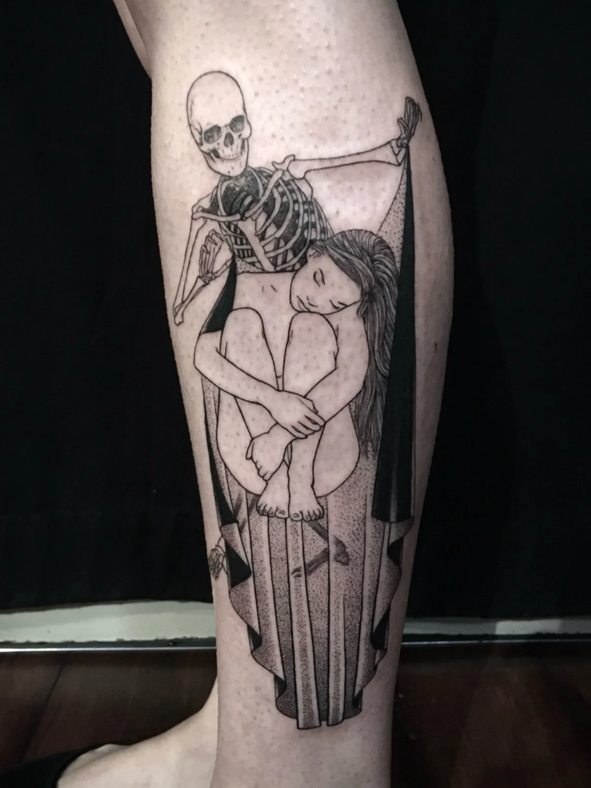Fine line black work tattoo of a skeleton draping cloth around a sleeping woman, created by Seattle tattoo artist Eli Bischof.