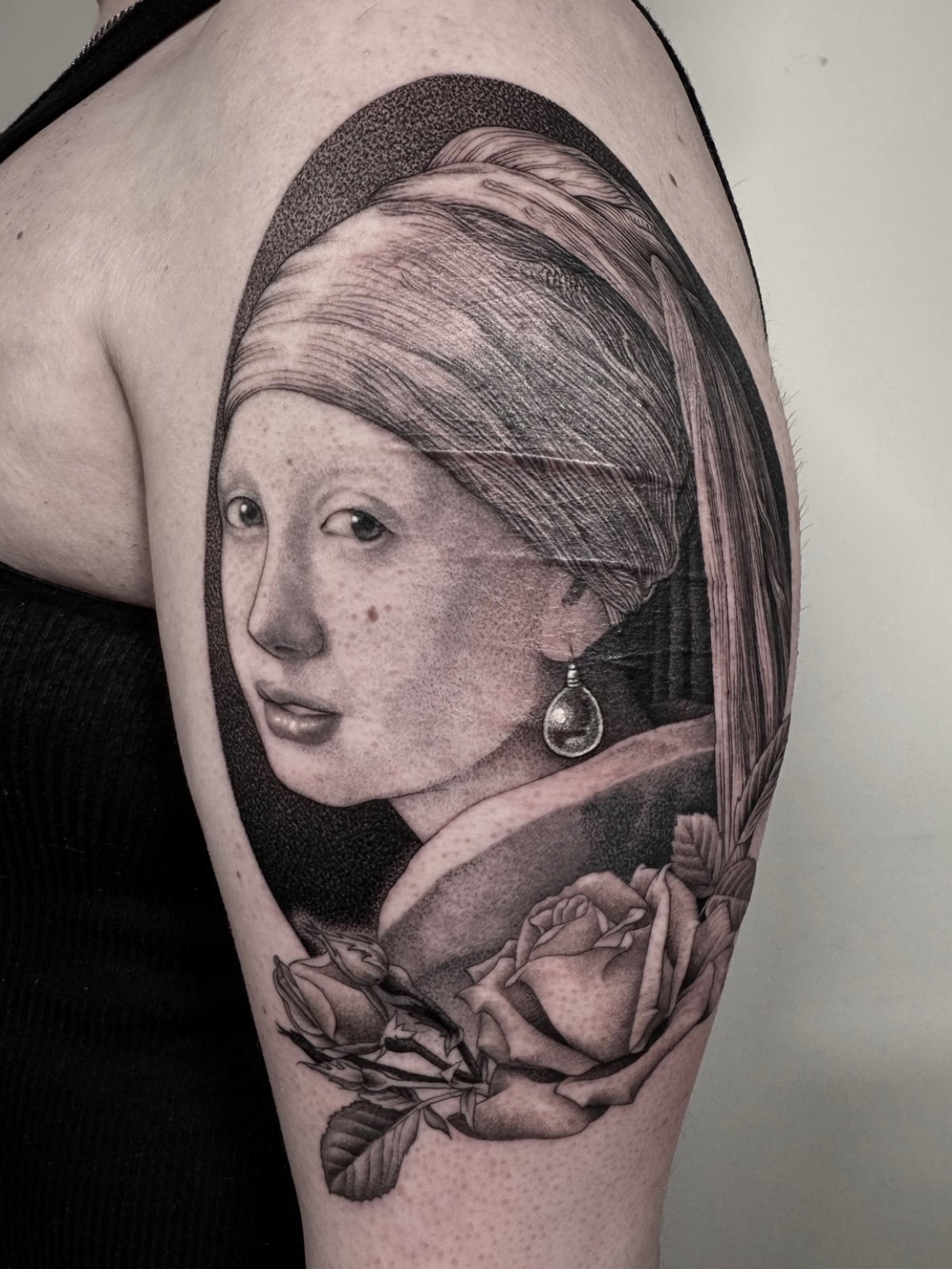 Fine line and black and grey tattoo portrait of Girl with a Pearl Earring, tattooed over scar tissue, created by Seattle tattoo artist Eli Bischof.
