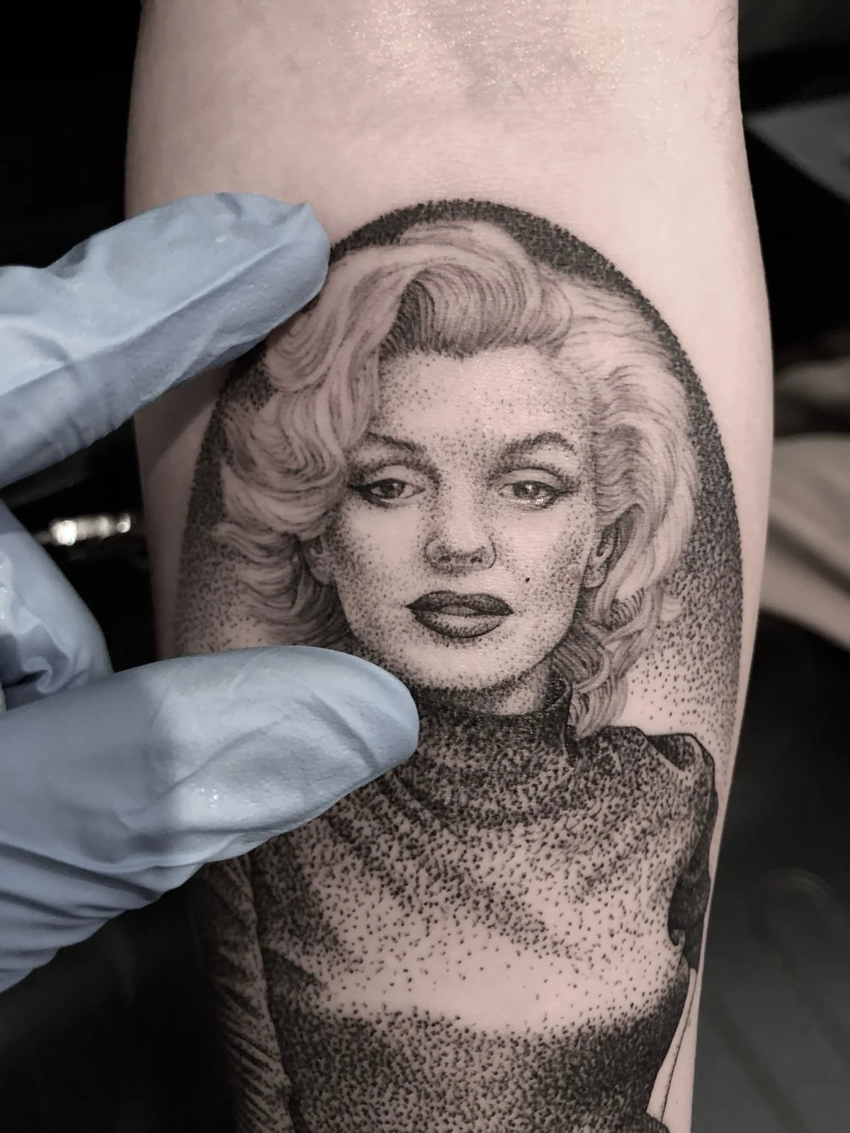 Close up detail photo of a fine line and black and grey portrait tattoo of Marilyn Monroe, created by Seattle tattoo artist Eli Bischof.