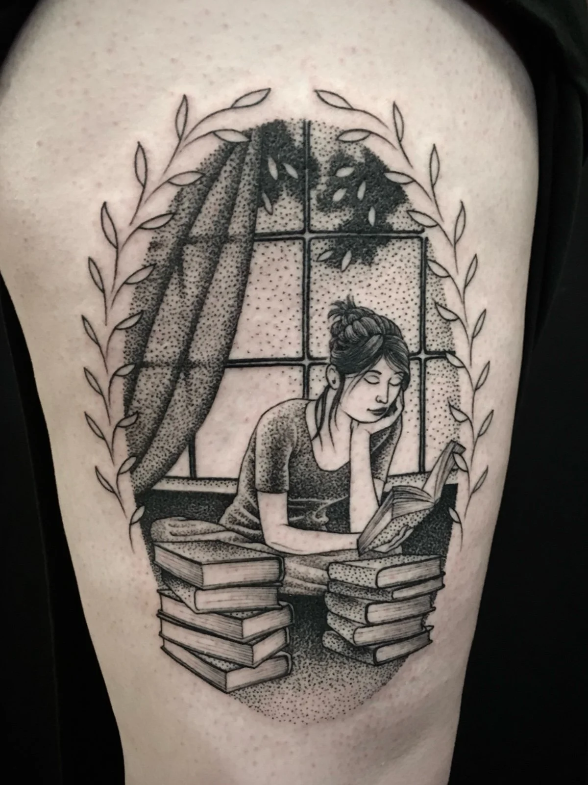 A fine line and black and grey tattoo with dotwork shading, depicting a young woman reading books by a window, created by Seattle tattoo artist Eli Bischof.