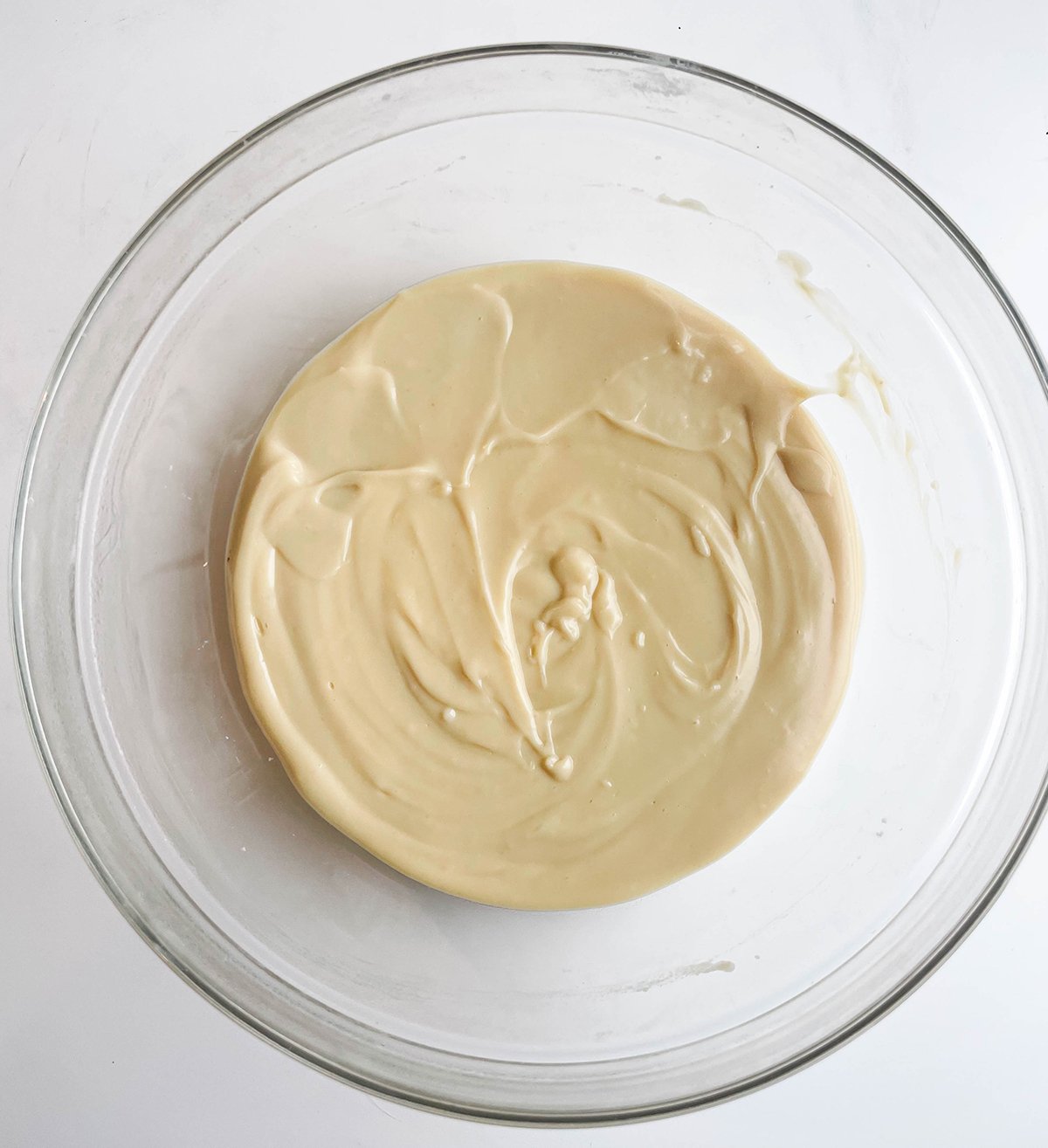 Pour into glass bowl, whisk in vanilla and butter until smooth.
