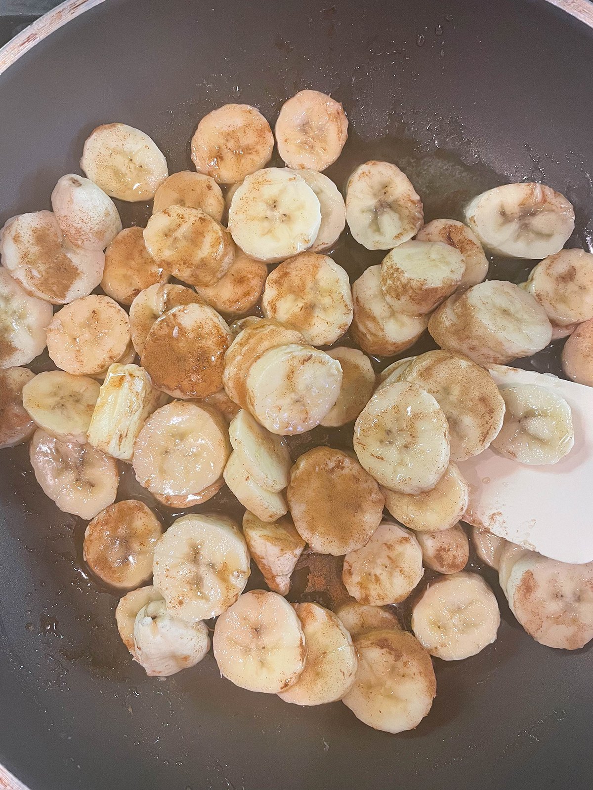 Add maple syrup, butter, cinnamon and bananas to a pan.