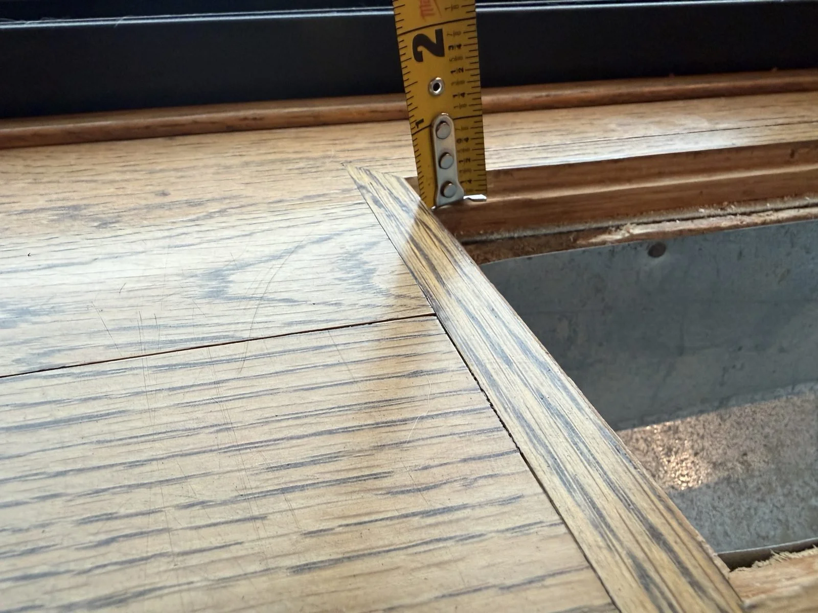 Measuring the depth of a recessed floor vent pocket for a flush-mount register