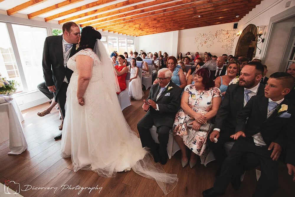 The arches Country House Borrotn wedding Photography Ceremony first kiss.jpg