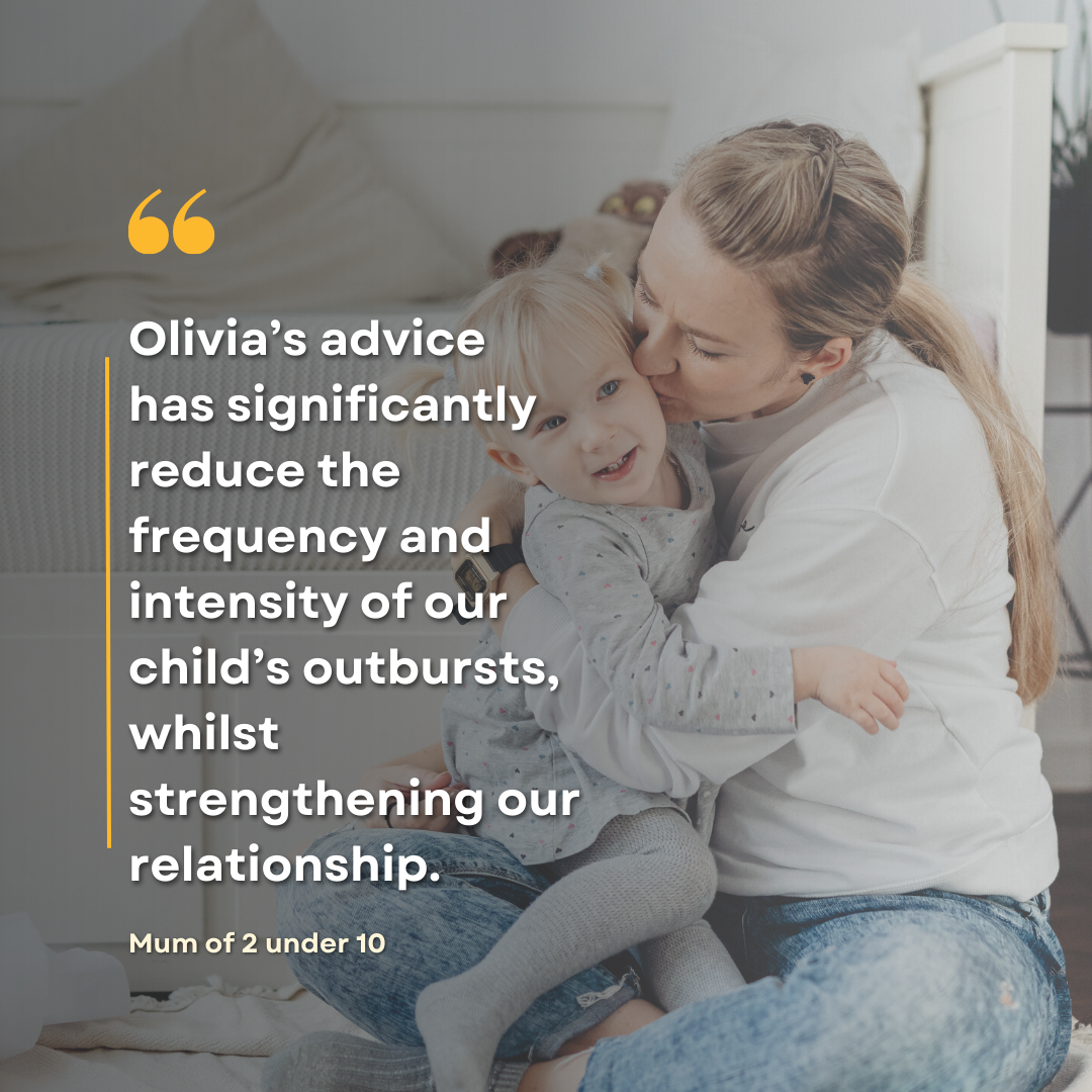 A mother kissing her young child, sitting on a bed in a cozy bedroom.