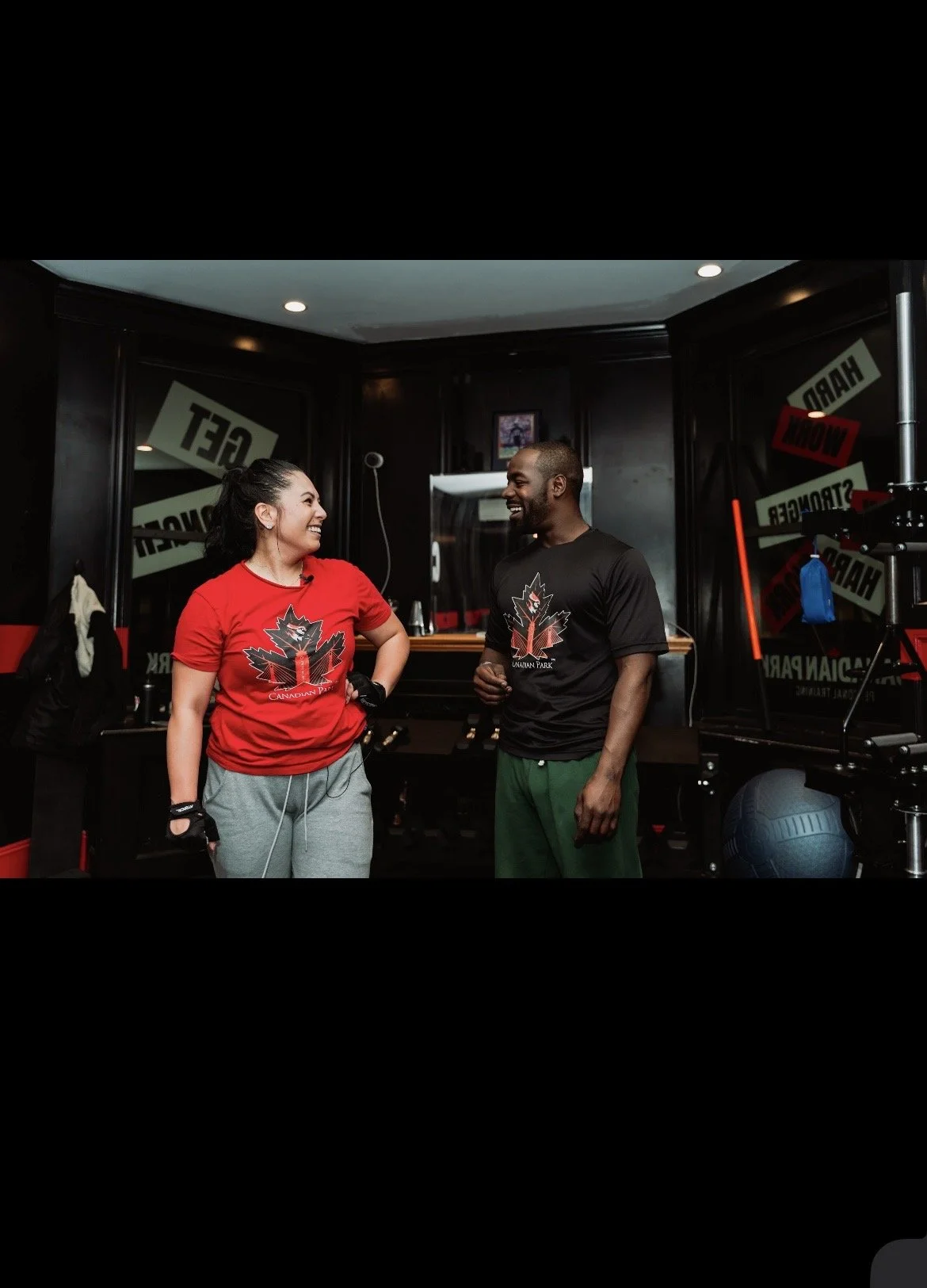 Personal trainer and female client sharing a laugh during a private personal training session at Canadian Park Training in Boston