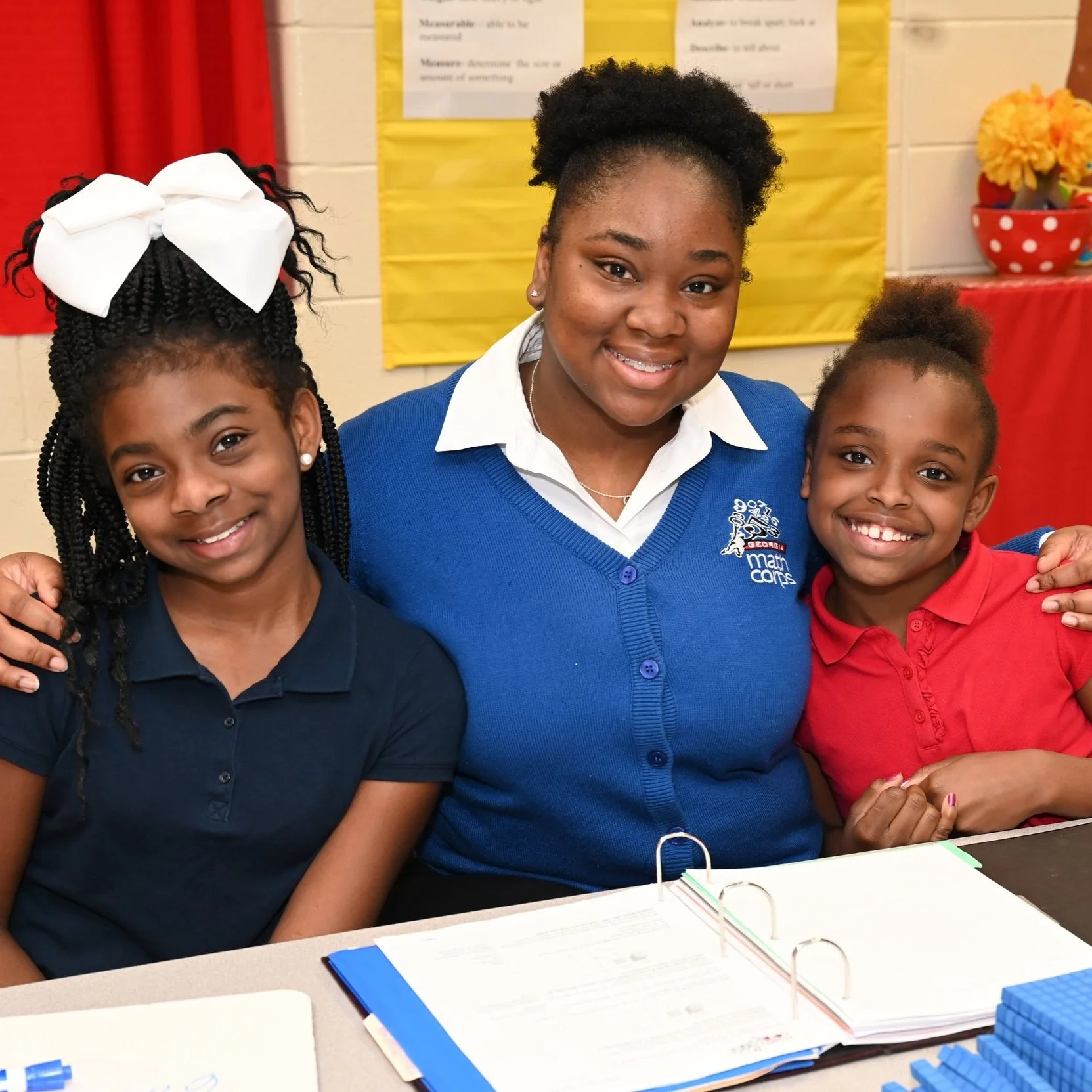 Georgia tutor smiling with two students