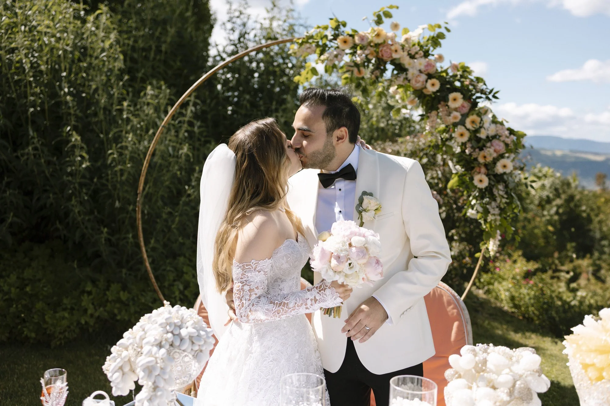 first kiss of the bride and groom during wedding ceremony in fernblick