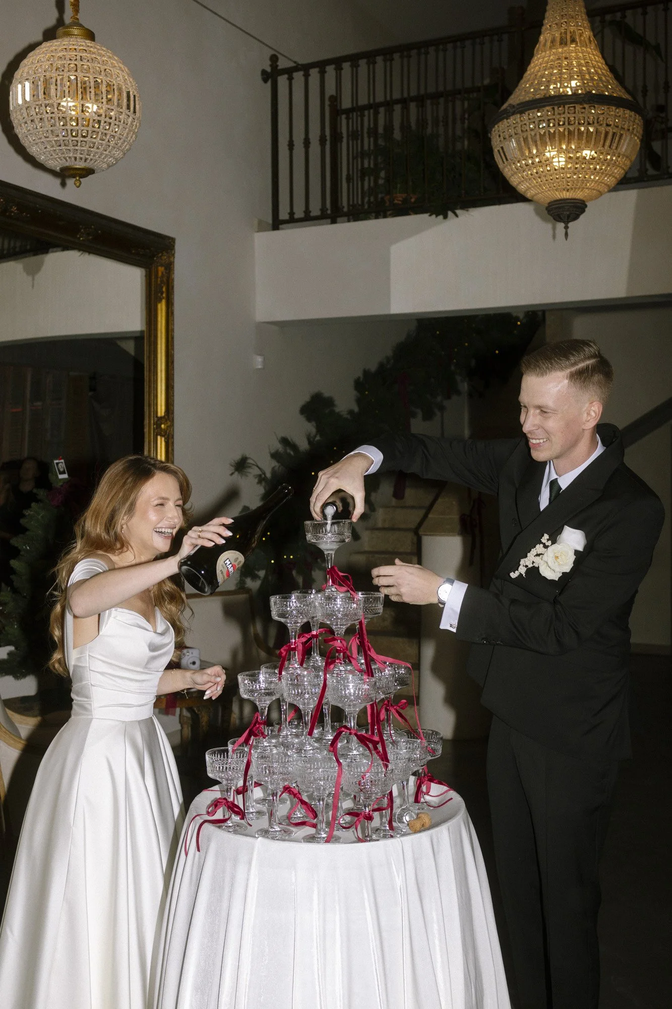 bride and groom with champagne tower during wedding at villa love