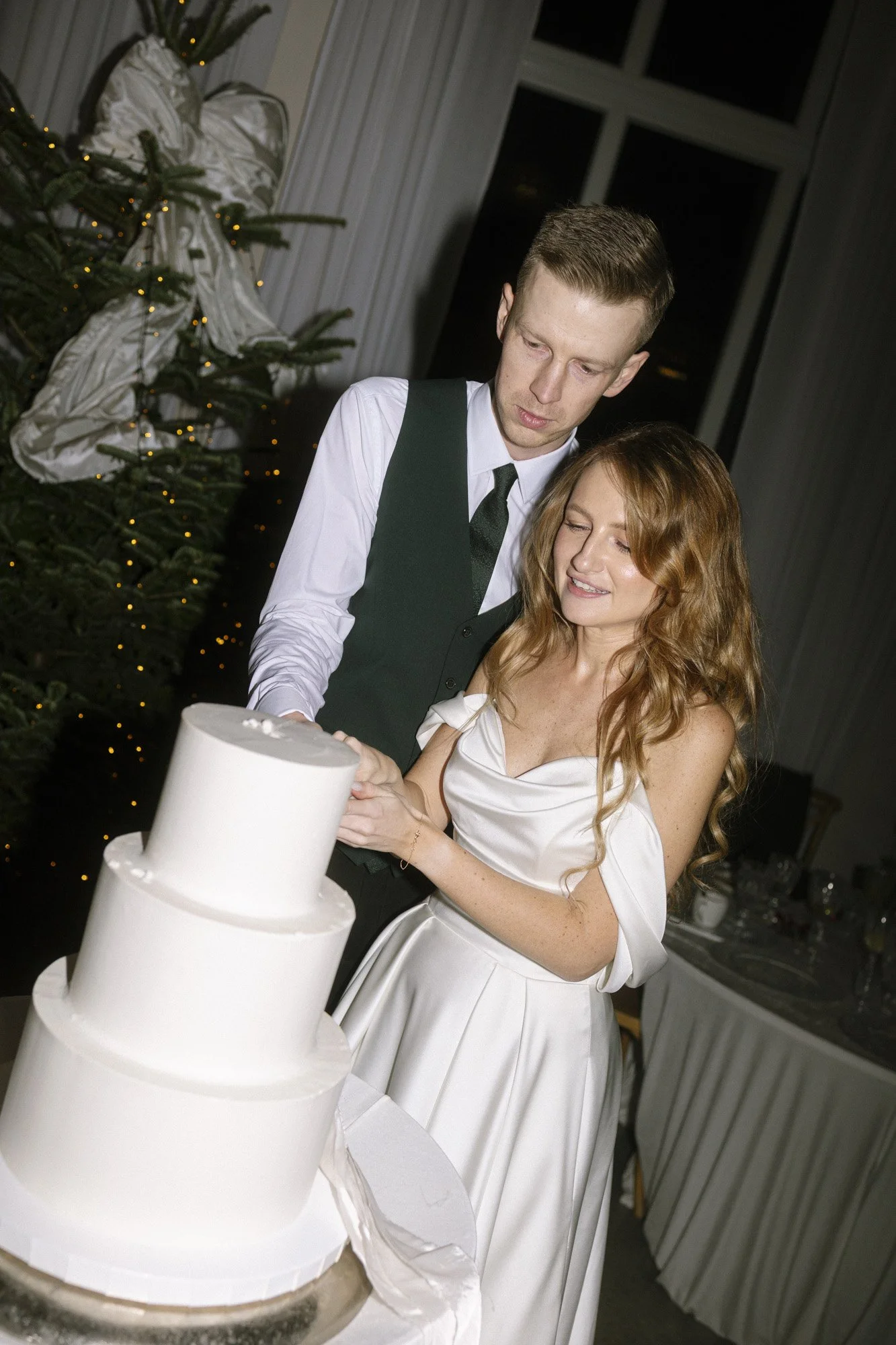 bride and groom cutting wedding cake at villa love