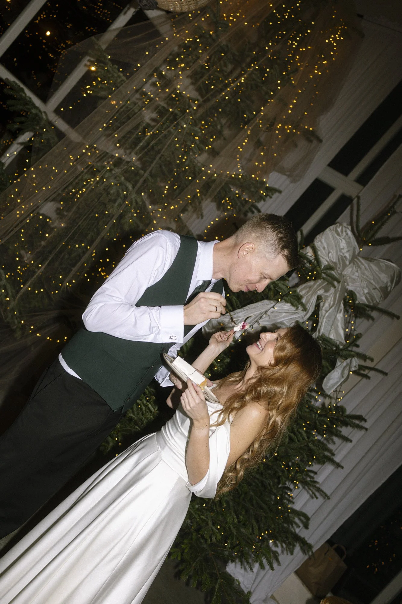 bride and groom eating wedding cake at villa love