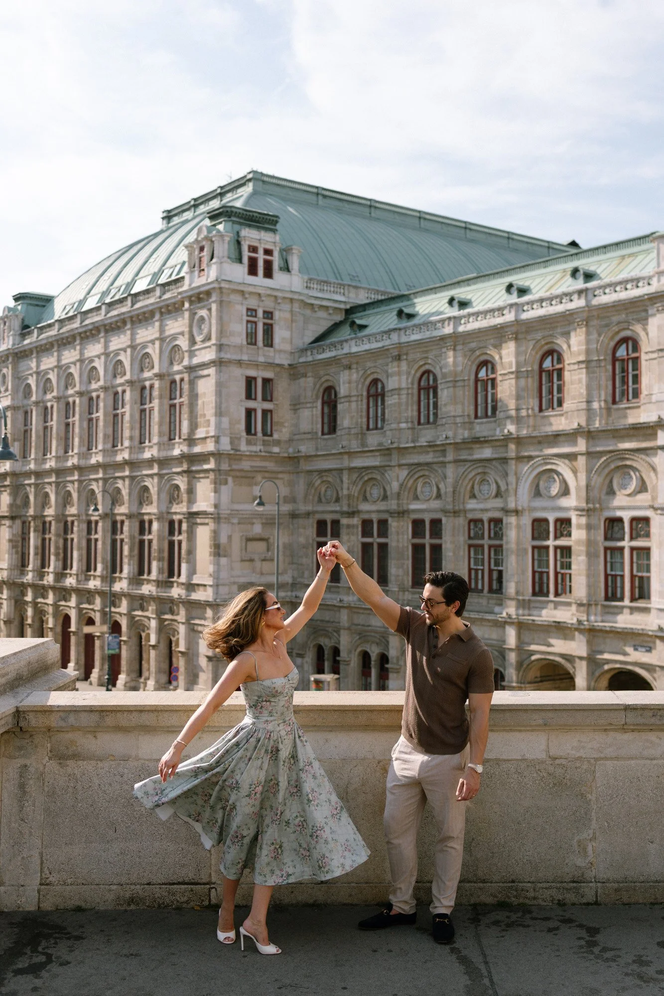 Romantic couple dancing in front of historic architecture in Vienna