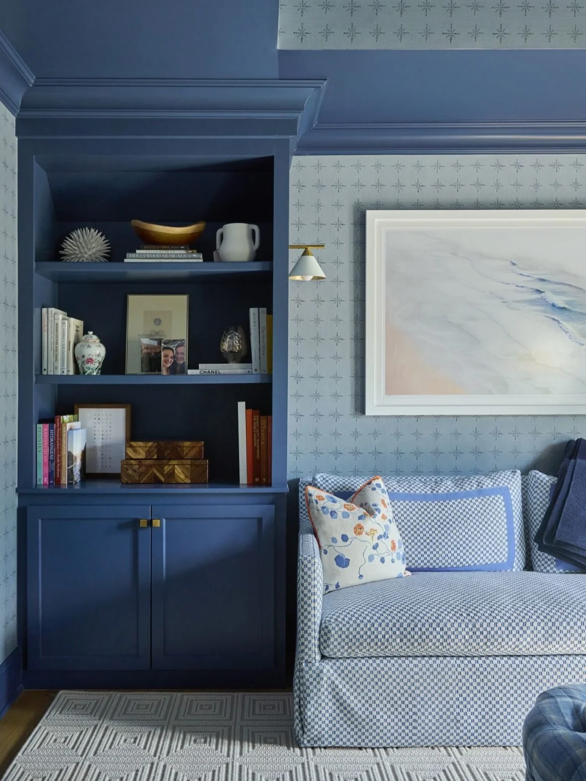 This is the kind of room that makes your body relax. 

Moody blues, a richly textured rug, and pattern on pattern turned this primary suite sitting room into a cozy hideaway. 

The bones were good, but it needed layers and personality. We wrapped the