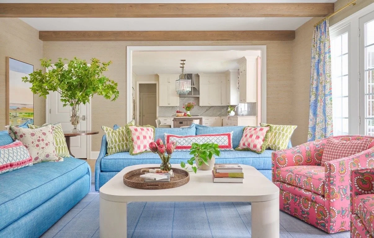 I designed this family room around color, but wanted it to feel collected rather than overly decorated. The grasscloth walls and warm wood beams create a quiet backdrop for watery blues, fresh greens and plenty of pink (our client&rsquo;s favorite co