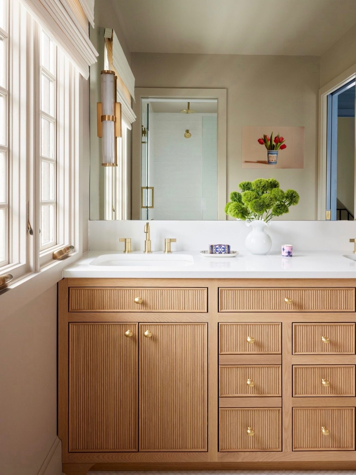 I&rsquo;m a firm believer in choosing beautiful, enduring materials for the rooms we use every single day. A primary bathroom should feel fresh and current, but never so tied to a trend that it quickly feels dated.

Warm reeded oak, unlacquered brass