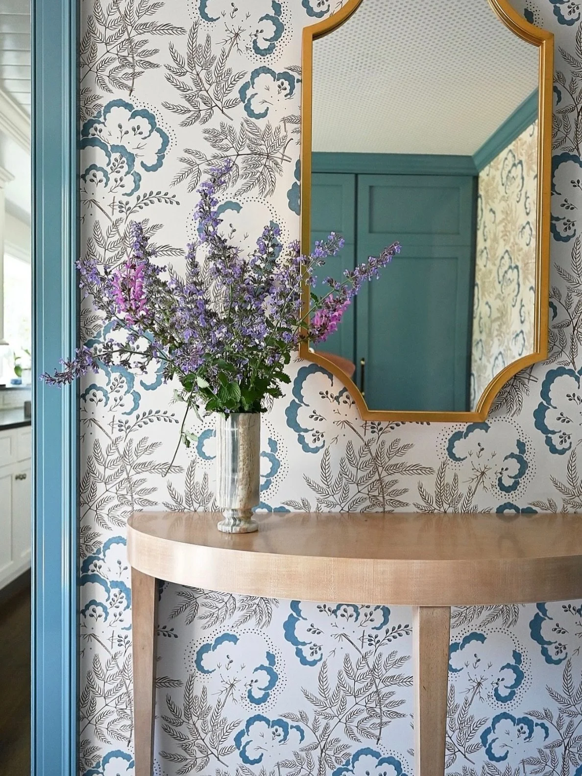 I have a soft spot for rooms that could easily be ho-hum. In this Greenwich mudroom, we began with floor-to-ceiling storage, then made it anything but utilitarian. The blue in the whimsical wallpaper inspired the glossy finish for the millwork, while