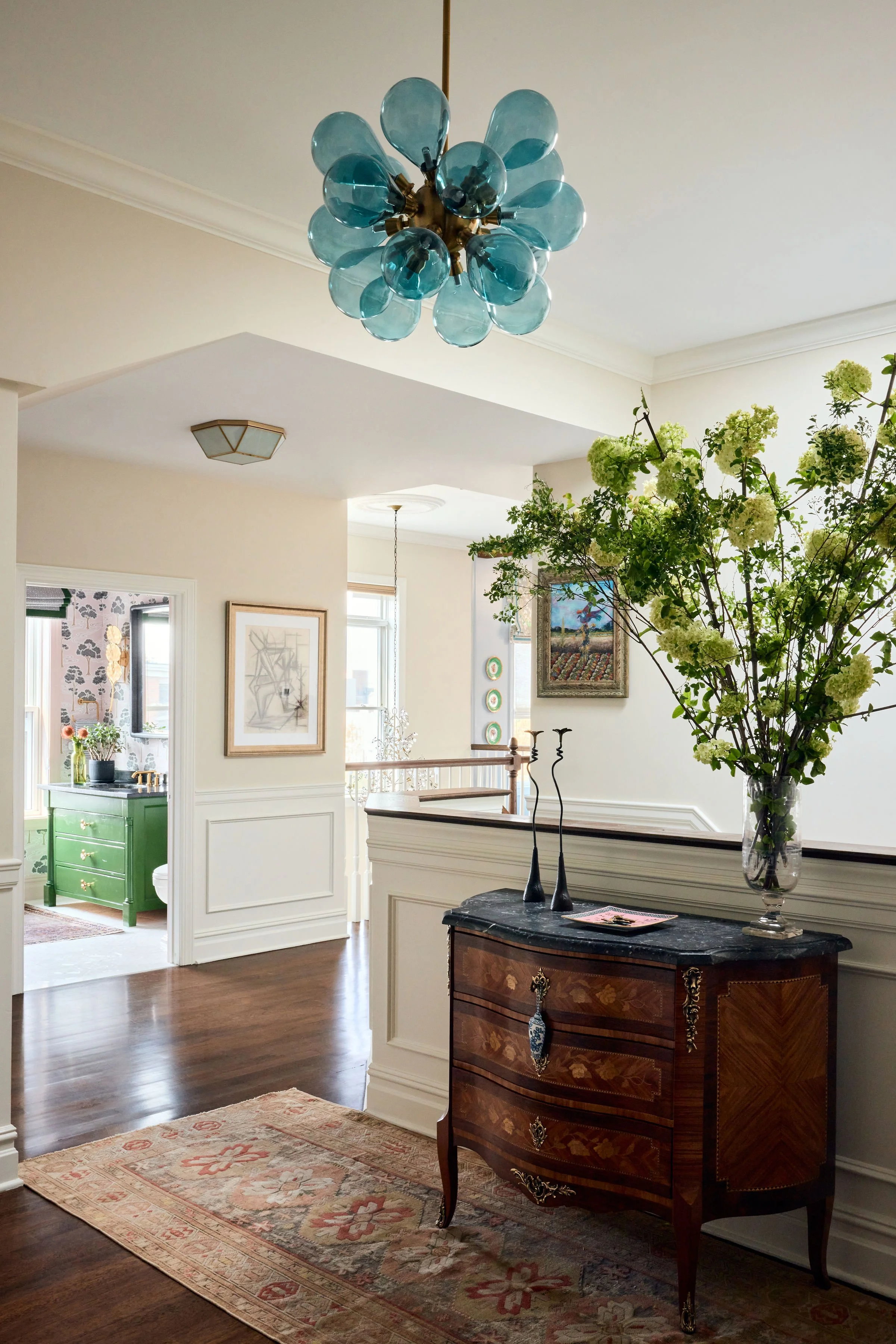 entryway with a vintage runner and view of bathroom