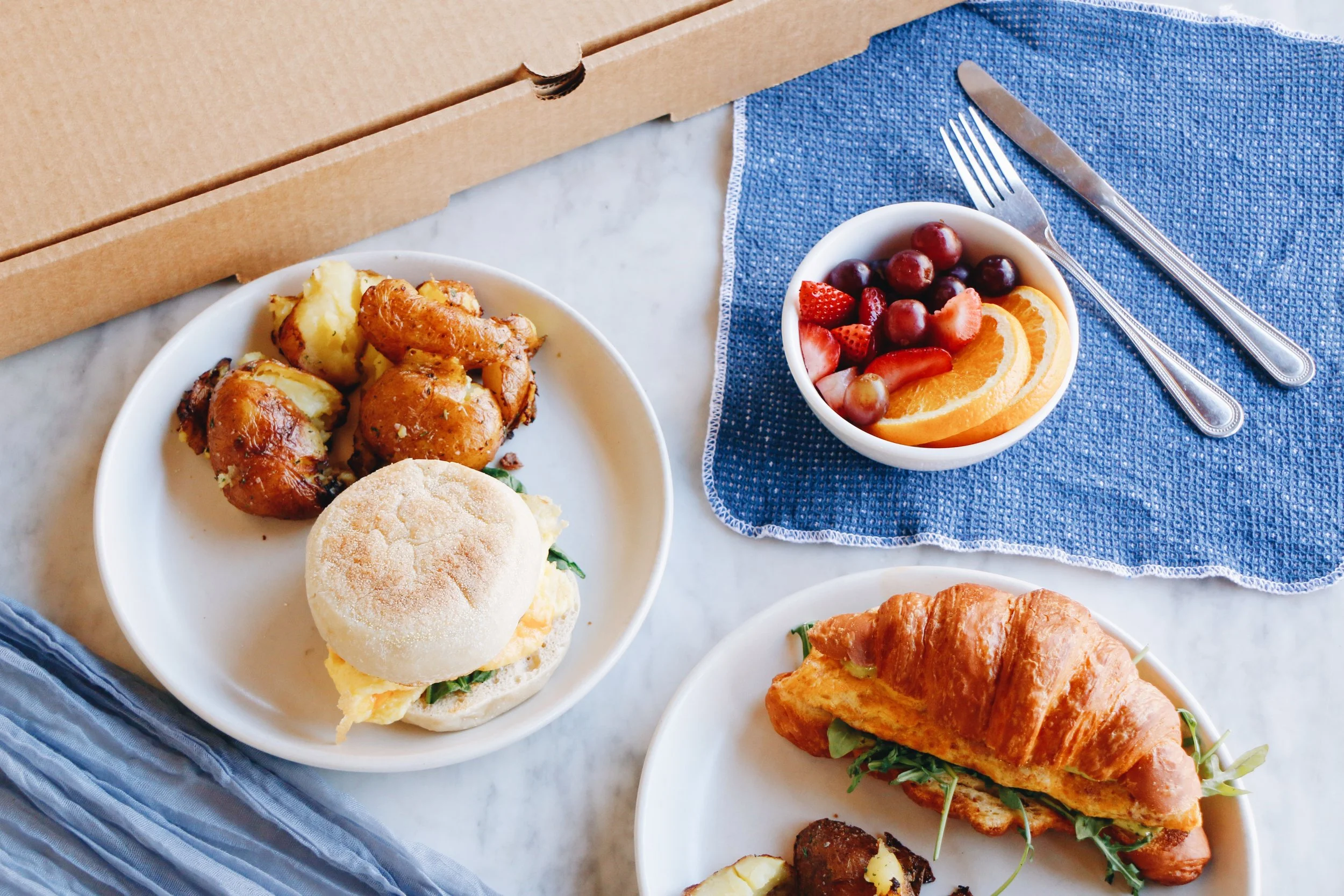 Prep and Pastry breakfast catering spread featuring croissants, potatoes, and fruit.jpg